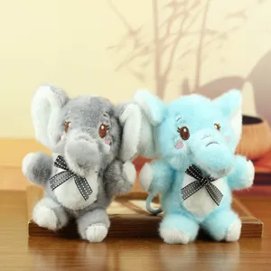 Cute elephant plush keychain detail shot, soft stuffed animal bag charm with cute bow.