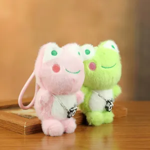 Detalle de llavero de peluche de rana lindo, dije de bolso de peluche suave con mini cámara.