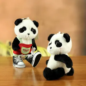 Cute panda plush keychain jointed stuffed animal toy with tiny canvas shoes and red overalls.