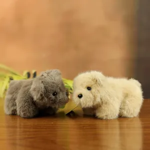 Cute plush toy pendant detail showing soft fluffy bear dolls in grey and beige colors.