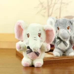 Cute elephant plush toy detail showing soft white and grey fabric with charming bow ties.