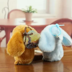 Plush rabbit pendant detail showing soft fluffy texture, cute long ears and decorative tag.