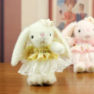 Plush bunny rabbit toy detail featuring soft white fur and a delicate yellow lace dress.