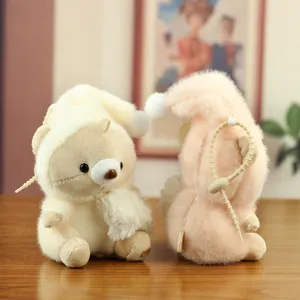 Close-up detail shot of cute sleeping nightcap bear plush toy pendants on a wooden table.