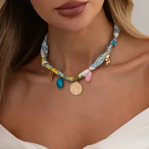 Detailed view of bohemian style silk ribbon choker necklace with metallic charms and coin pendant.