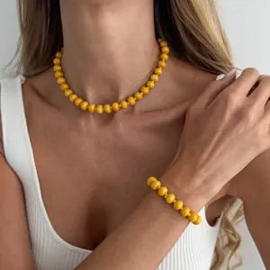Gelbes Perlenkette und Armband Set Nahaufnahme, lebendiger Sommerschmuck Detail für Damen.