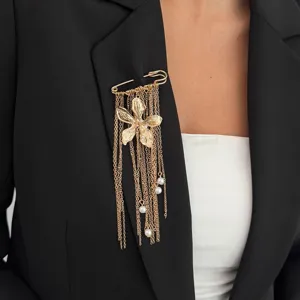 Golden safety pin brooch with metallic flower fringe and hanging pearl charms for chic styling