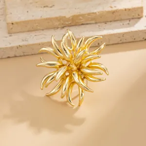 Close-up of gold 3D irregular flower brooch, detailed metal texture for party banquet wear.