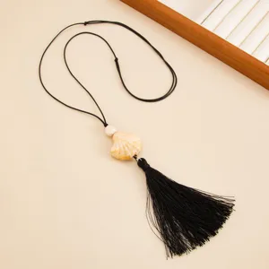 Long black wax cord sweater chain featuring a resin fan shell pendant and a chic tassel.