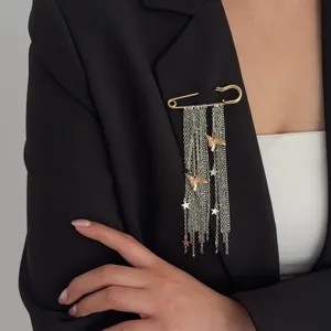 Elegant tassel chain safety pin brooch detail showcasing delicate bird and star charms for women.