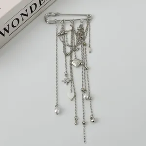 Silver safety pin brooch with multi-strand chains, pearl beads, and heart pendants for women.