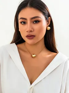 Minimalist gold snake bone chain necklace and round bead choker for women detail view.