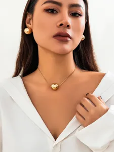Gold snake chain sphere pendant necklace detail shot showcasing the minimalist geometric jewelry style.
