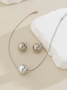 Minimalist silver snake chain necklace and sphere earrings set, modern geometric punk jewelry.
