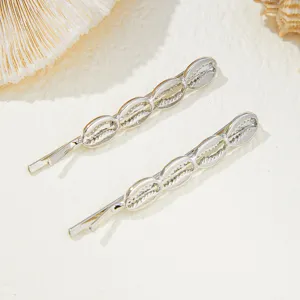 Silver seashell hair clip detail shot, elegant beach style bobby pin accessory for women and girls.