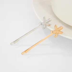 Close-up detail of stylish starfish bobby pins, elegant beach style metallic hair accessories.