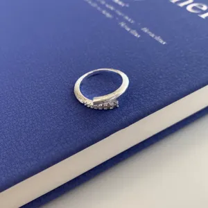 Exquisite minimalist silver open ring with delicate textured detail and sparkling micro-set stones.