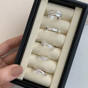 Set of five minimalist silver open rings featuring textured, zircon and solitaire designs for women.