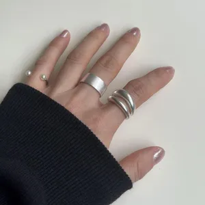 Close-up detail of women's geometric silver ring set, featuring matte finish and open design.