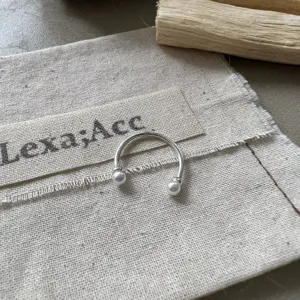 Silver open ring with pearl ends, elegant everyday jewelry accessory for modern women.