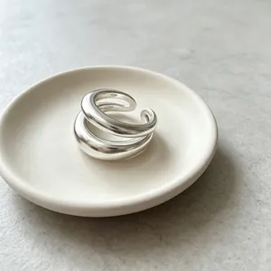 Exquisite multi-layer geometric matte open ring, minimalist silver tone design detail view.