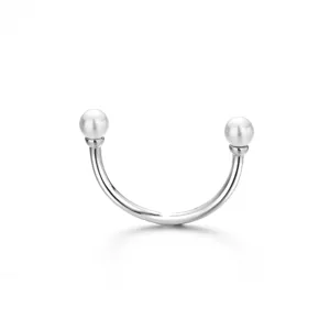 Close-up detail of silver open ring with dual pearl ends, minimalist aesthetic jewelry shot.