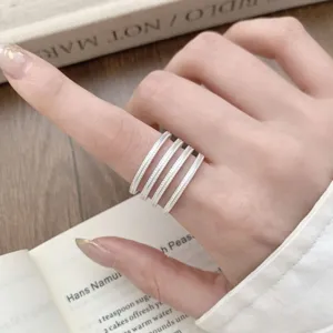 Multi-layer silver ring, minimalist textured design, stylish open band for chic finger wear.