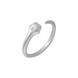 Close-up detail of silver open ring featuring cute paw design with sparkly cubic zirconia stones.