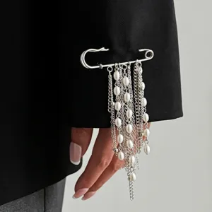Elegant pearl tassel brooch close-up, fashion silver safety pin jewelry for women banquet.