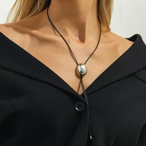 Minimalist black cord necklace with sleek silver oval pendant for women chic jewelry style