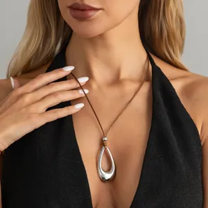 Fashion minimalist long necklace with silver hollow teardrop pendant on brown cord.