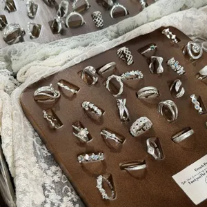 Detail shot of assorted silver stackable rings featuring twist and geometric open designs.