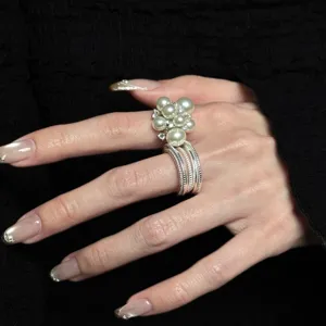 Close-up detail of multi-layer pearl open ring, elegant sweet style finger jewelry for women.