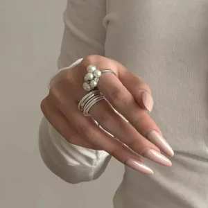 Close up detail showcasing the stylish imitation pearl and multi layer metal ring.