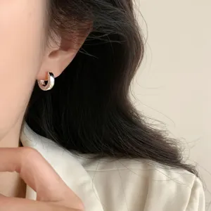 Minimalist thick silver hoop earrings detail, chic chunky small metal ear rings for women.