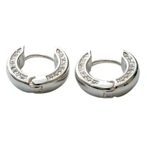 Detailed close-up view of silver pavé huggie hoop earrings with sparkling cubic zirconia stones.