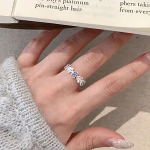 Silver tone clover flower ring with sparkling white and blue zirconia stones for women variant
