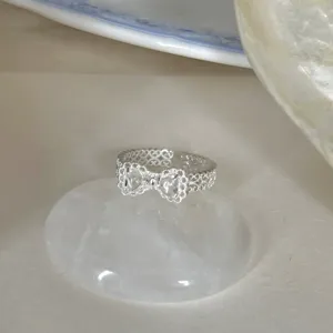 Nahaufnahme des eleganten silbernen offenen Rings mit filigranem Schleifendesign für den Alltag.
