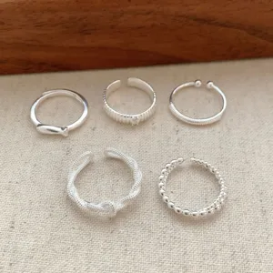 Set of five versatile silver open rings featuring minimalist textured details for daily wear.