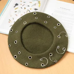 Details of the punk style wool beret featuring metal rings and eyelets, perfect for autumn winter.