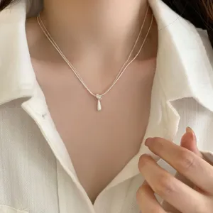 Delicate double-layer silver necklace featuring a minimalist teardrop pendant for women.