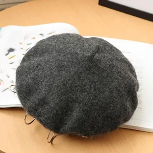 Dark gray wool beret detail shot, featuring unique metal rings, autumn winter punk style hat.