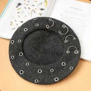 Dark grey wool beret with metal piercing rings, punk style winter fashion hat for women.