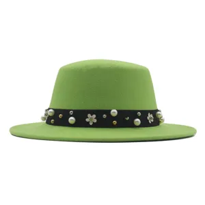 Close-up view of the green flat top fedora hat detail, featuring pearl and flower band decoration.