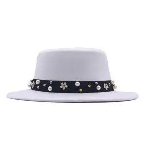 Elegant white flat top felt hat for women featuring a black ribbon with pearls and flower studs.