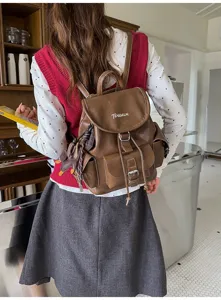 Vintage brown leather backpack for women, college commute school bag with multiple pockets.