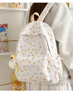 Floral fabric backpack for women, cute school bag with pockets and plush pendant.