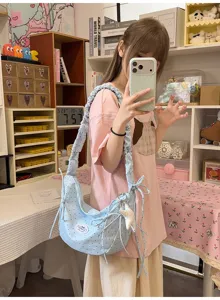 Sweet light blue polka dot hobo shoulder bag with ruffled straps and cute bow charms for women.