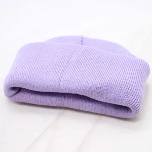 Detailed view of a soft light purple knitted beanie, solid color winter warmth hat.