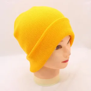 Bright yellow ribbed knit beanie hat, cozy winter streetwear accessory, solid color design.
